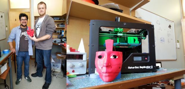 Eduardo Sandoval and Tim Pomroy with the robot's face, and the 3D printer